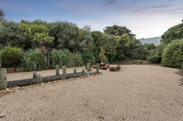 Rear garden at a Mount Martha coastal property with fresh Goulburn screenings and fire pit area